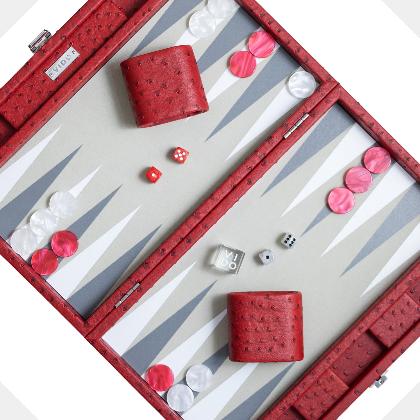 Backgammon set with red pieces and dice on a white background by VIDO