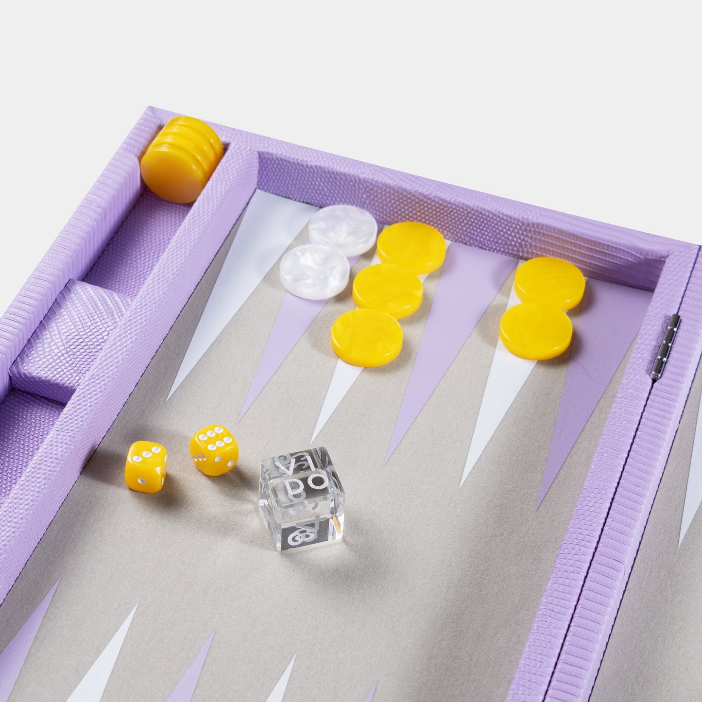 Backgammon set including yellow and white dice and checkers on a purple board by VIDO