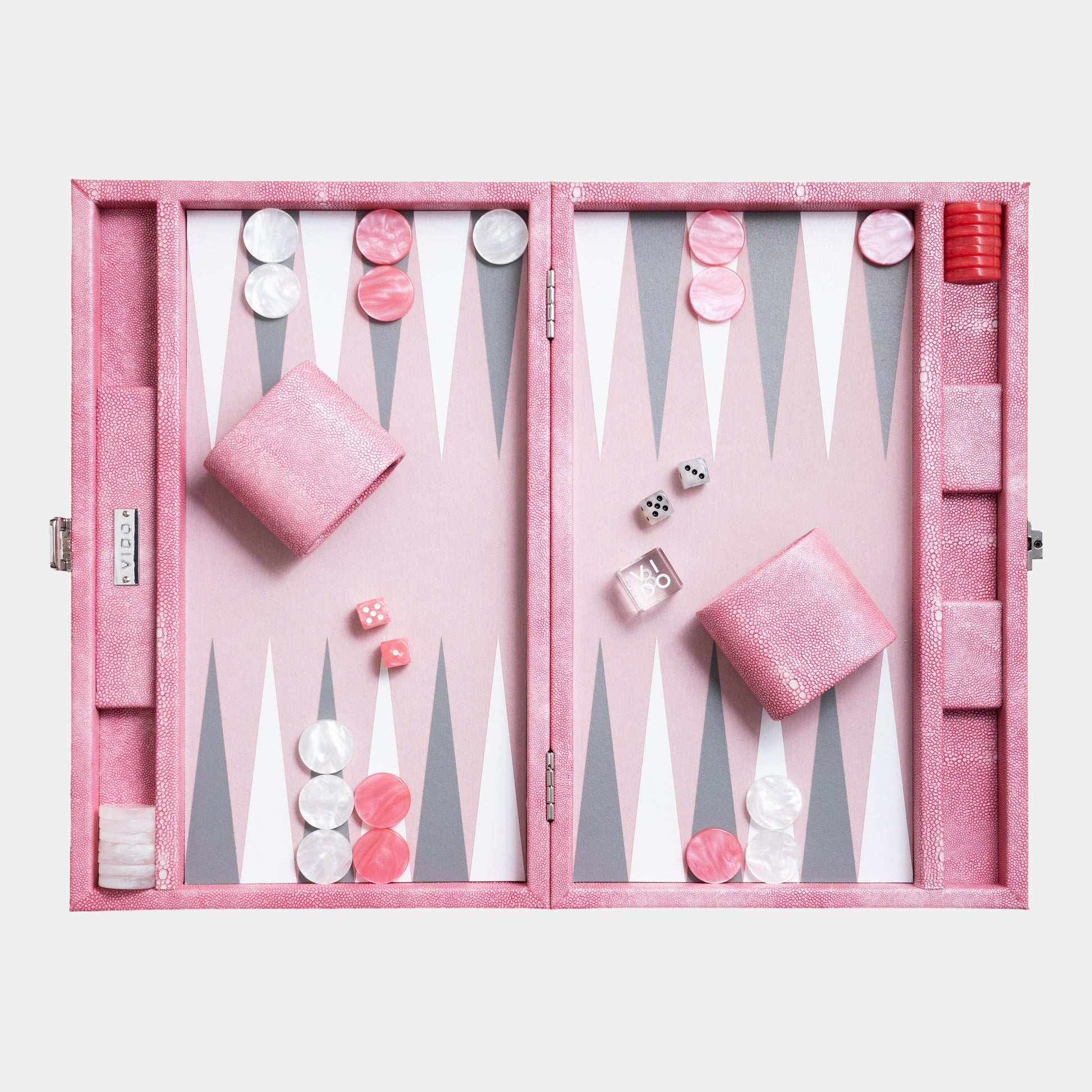 Pink backgammon set with pieces and dice on a white background by VIDO