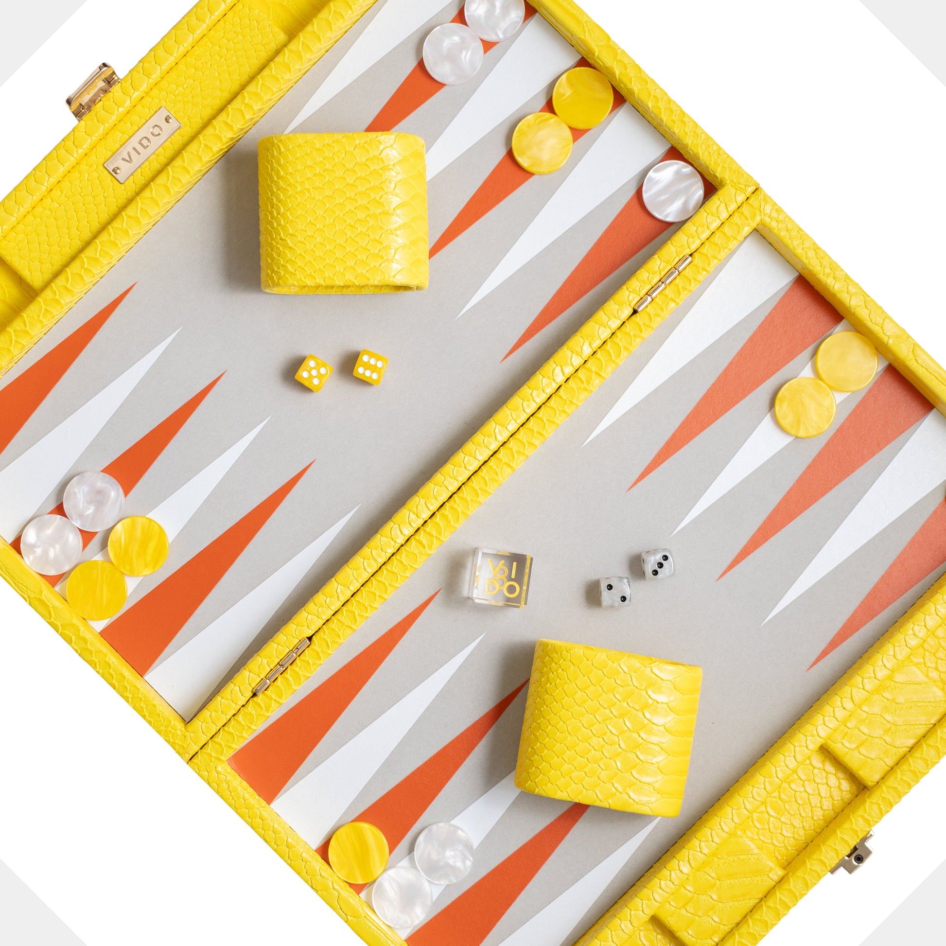 Backgammon set with yellow and white pieces on a white background by VIDO